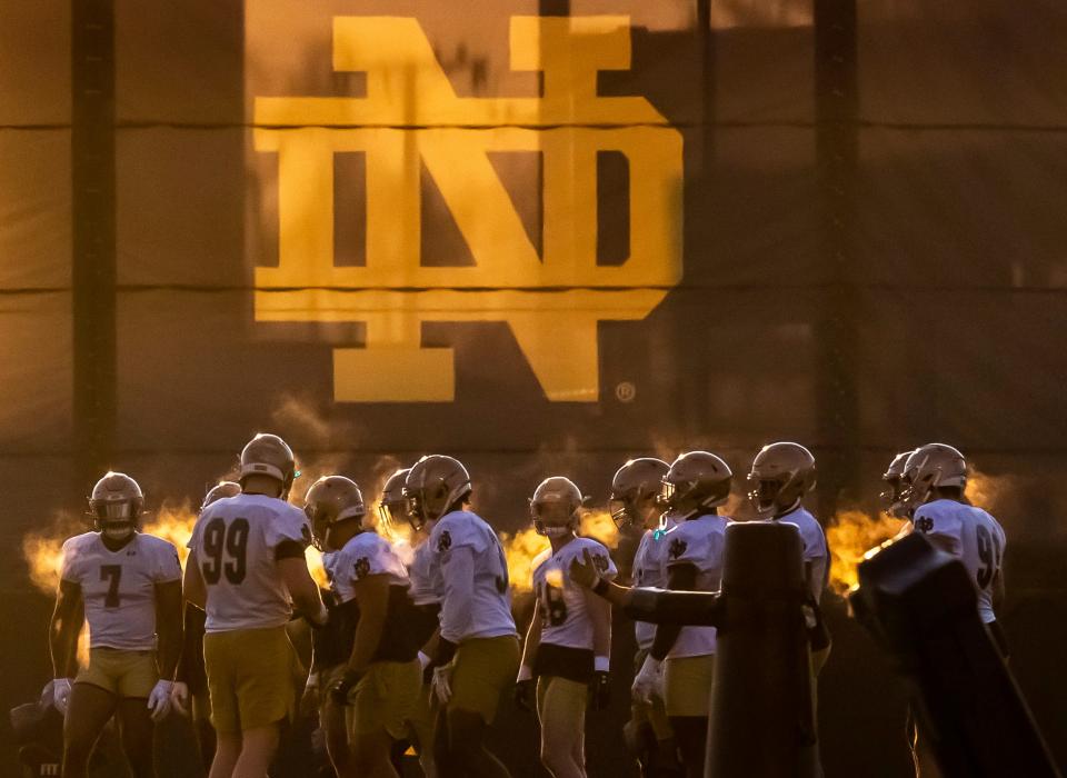 Notre Dame defensive players head outside to run dills during a Notre Dame football spring practice.