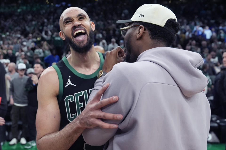 Boston Celtics guard Derrick White, left, embraces Cleveland Cavaliers guard Donovan Mitchell after the Celtics won 113-98 in Game 5 of an NBA basketball second-round playoff series Wednesday, May 15, 2024, in Boston. The Celtics advanced to the Eastern Conference finals. (AP Photo/Charles Krupa)