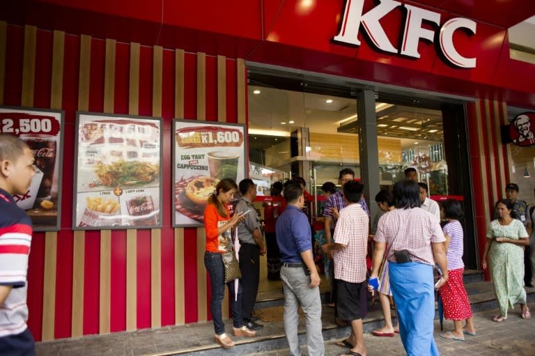 Customers wait outside KFC in Yangon on June 30, 2015, for the opening of the first major US fast food chain in Myanmar