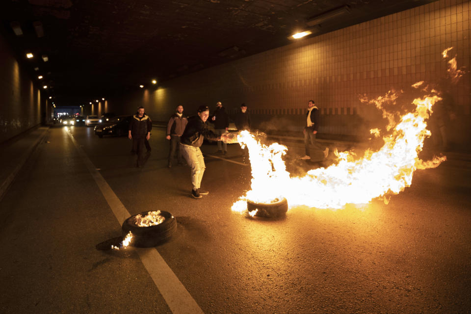 Supporters of Prime Minister-designate Saad Hariri block a road link to Beirut international airport in Beirut, Lebanon, Monday, March 22, 2021. Protesters blocked some roads in the Lebanese capital with burning tires Monday after talks on the formation of a new Cabinet broke down, heralding more economic and financial collapse for the small Arab country. (AP Photo/Hassan Ammar)