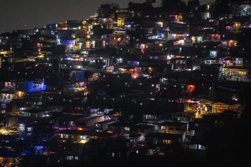 A slum colony is decorated with lanterns and lights during Diwali, the festival of lights in Mumbai, India, Monday, Oct. 24, 2022. (AP Photo/Rafiq Maqbool)