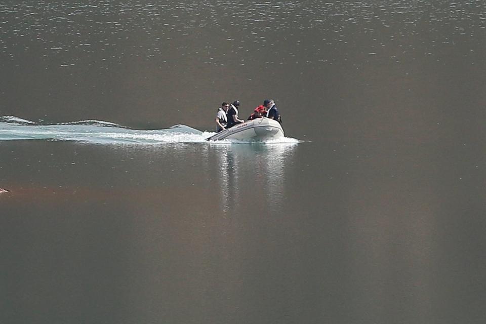 A search dingy navigates in the Arade dam (AP)