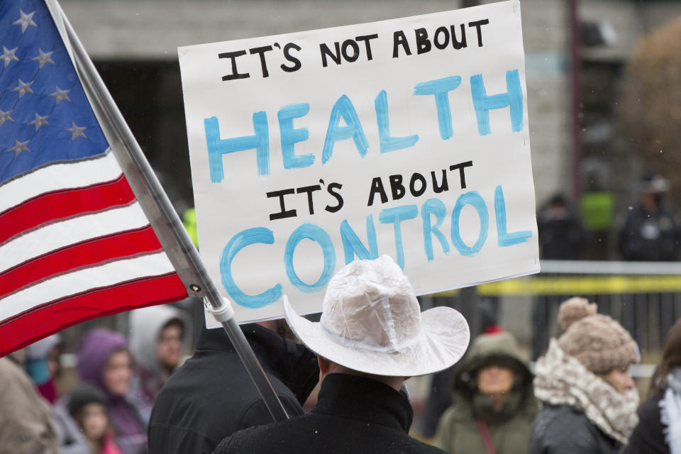 Protesters gather outside Central District Health's office in Boise, Idaho, on Tuesday, Dec. 15, 2020. CDH was meeting virtually to consider a mask mandate. (AP Photo/Otto Kitsinger)