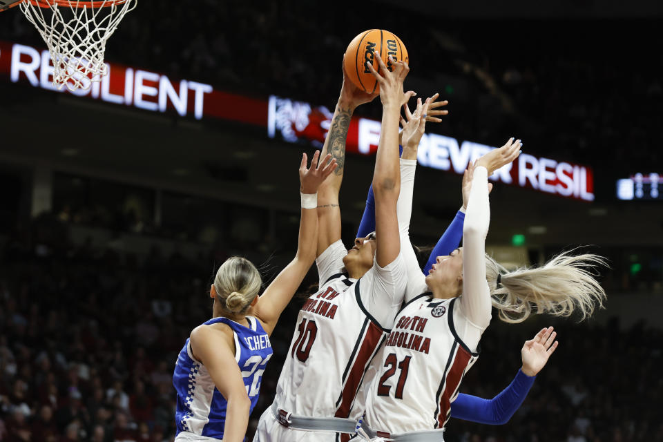 South Carolina center Kamilla Cardoso (10) rebounds over South Carolina forward Chloe Kitts (21) and Kentucky guard Maddie Scherr, left, during the first half of an NCAA college basketball game in Columbia, S.C., Monday, Jan. 15, 2024. (AP Photo/Nell Redmond)