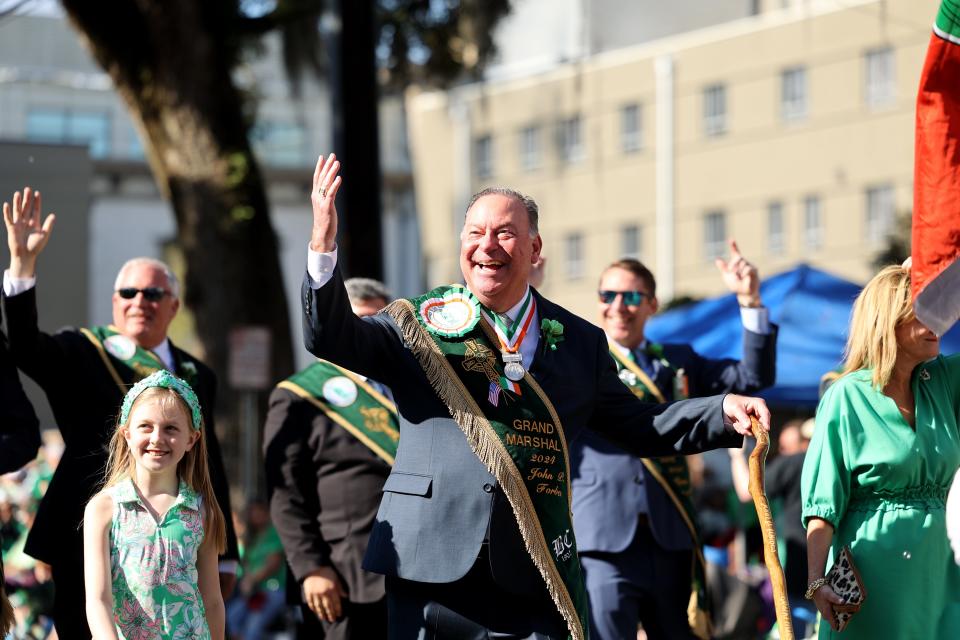 Parade Grand Marshal John Forbes encourages the crowd during the annual Savannah St. Patrick's Day Parade on Saturday, March 16, 2024.
