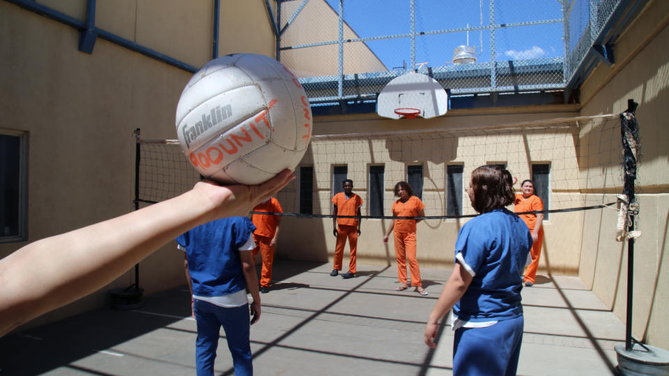 This June 6, 2019 image provided by U.S. Immigration and Customs Enforcement shows immigration detainees playing volleyball in the recreation yard of a dedicated unit for transgender migrants in the Cibola County Correctional Center in Milan, N.M. (Ron Rogers/U.S. Immigration and Customs Enforcement via AP)