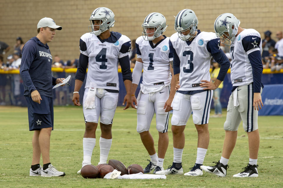 The Dallas Cowboys reportedly may promote quarterbacks coach Kellen Moore, far left, to offensive coordinator. (AP)