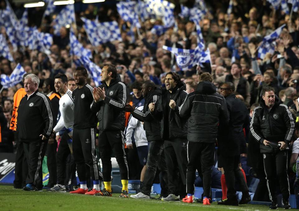 Members of the Chelsea team celebrates in the technical area after thier Champions League quarterfinal second leg soccer match between Chelsea and Paris Saint Germain at Stamford Bridge stadium in London, Tuesday, April 8, 2014. Chelsea advance to the semifinals. (AP Photo/Matt Dunham).