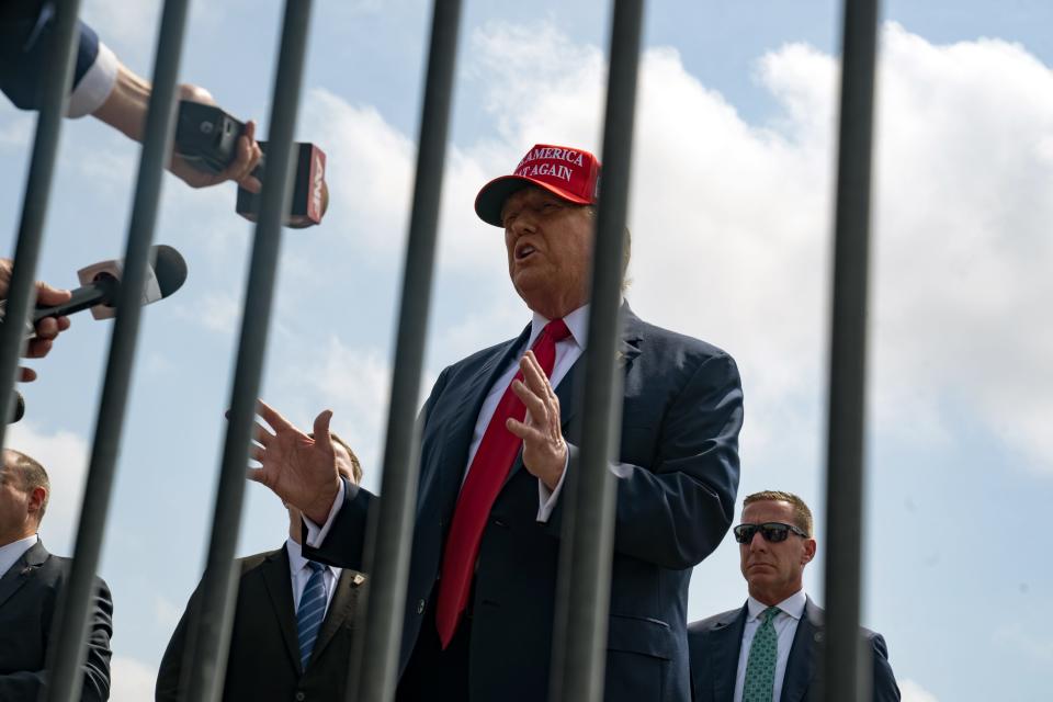 Former President Donald Trump speaks to reporters after arriving on April 10, 2024, in Atlanta for a campaign fundraising event.