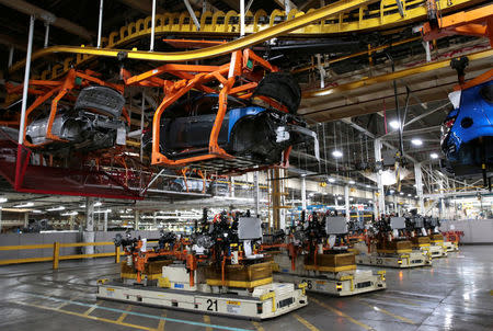 Automated Guided Vehicles transport the chassis for 2018 Chevrolet Bolt EV vehicles on the assembly line at General Motors Orion Assembly in Lake Orion, Michigan, U.S., March 19, 2018. REUTERS/Rebecca Cook/Files