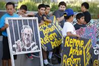 FILE - In this May 25, 2016, file photo, people protest against former sheriff Joe Arpaio rally in front of Maricopa County Sheriff's Office Headquarters in Phoenix. Arpaio is running again to get back his old job as sheriff of metro Phoenix. His 24 years as sheriff were defined by a series of tough-on-crime tactics and legal problems that cost taxpayers millions of dollars. (AP Photo/Ross D. Franklin, file)