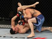 Roland Delorme (bottom) attempts to submit Josh Ferguson with a triangle choke during The Ultimate Fighter 14 Finale at the Pearl Theatre at the Palms Hotel and Casino on December 3, 2011 in Las Vegas, Nevada. (Photo by Josh Hedges/Zuffa LLC/Zuffa LLC via Getty Images)