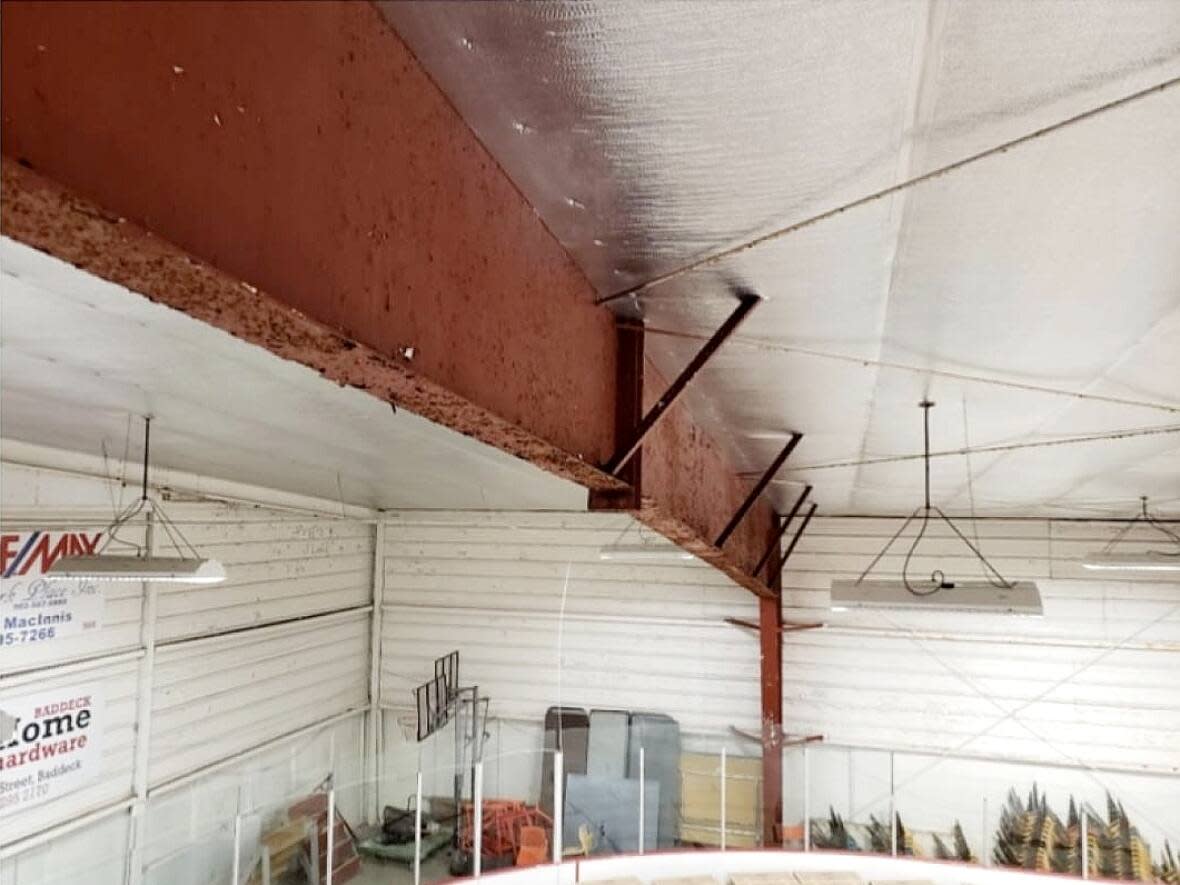 An image from an engineer's report into the Victoria Highland Civic Centre in Baddeck shows a rusting steel beam. Officials plan to open the rink this winter, but one end will be blocked off. (Submitted by Katie Ross - image credit)