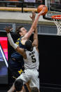 Purdue guard Brandon Newman (5) blocks the shot of Michigan guard Franz Wagner (21) during the second half of an NCAA college basketball game in West Lafayette, Ind., Friday, Jan. 22, 2021. (AP Photo/Michael Conroy)