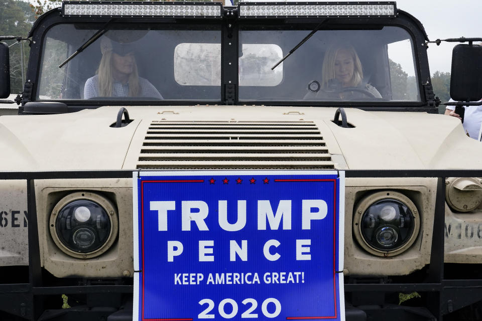 Sen. Kelly Loeffler, R-Ga., left, and Republican congressional candidate Marjorie Taylor Greene, right, leave after a news conference on Thursday, Oct. 15, 2020, in Dallas, Ga. (AP Photo/Brynn Anderson)