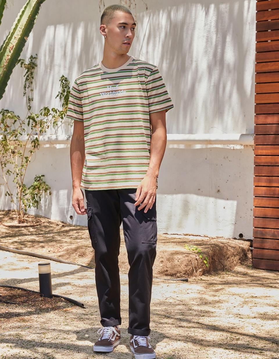 man wearing black cargo pants and stripe top