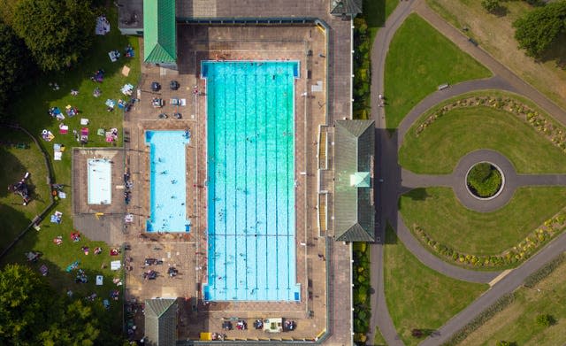 People cool off at Peterborough Lido in Cambridgeshire as the heatwave continues in the UK