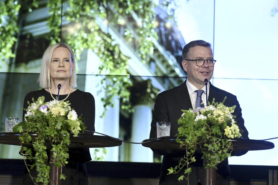 The new Government of Finland led by Prime Minister Petteri Orpo, right, and the new Minister of Finance Riikka Purra hold a press conference in Helsinki, Finland Tuesday, June 20, 2023. (Jussi Nukari/Lehtikuva via AP)