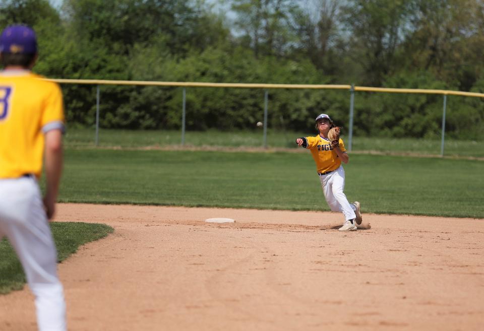 Hagerstown sophomore Ben Williams throws the ball to first base during warmups before a Wayne County Tournament game May 14, 2022.