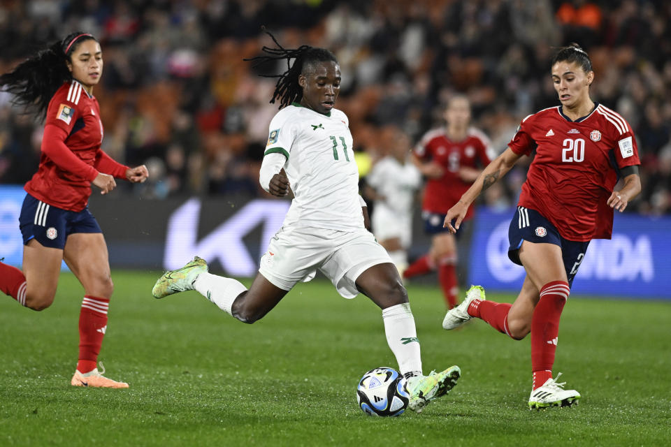 Zambia's Barbra Banda takes a shot on goal as Costa Rica's Fabiola Villalobos, right, watches during the Women's World Cup Group C soccer match between Costa Rica and Zambia in Hamilton, New Zealand, Monday, July 31, 2023. (AP Photo/Andrew Cornaga)