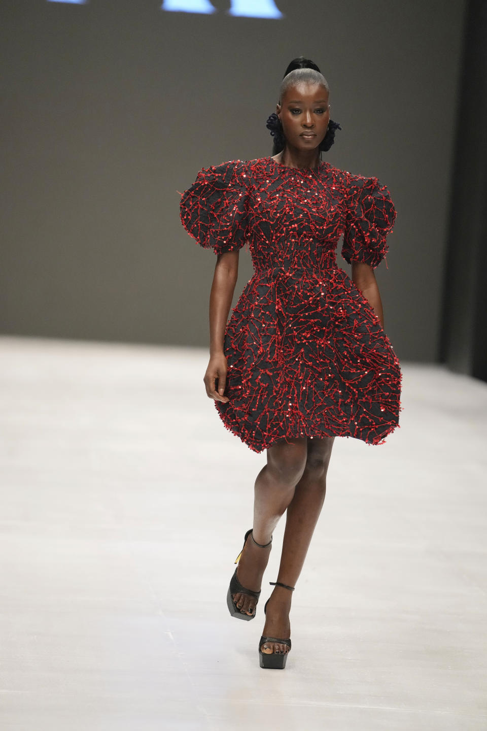 A model wears a creation by Ladymaker during the Lagos Fashion Week in Lagos, Nigeria, Thursday, Oct. 26, 2023. Africa's fashion industry is rapidly growing to meet local and international demands but a lack of adequate investment still limits its full potential, UNESCO said Thursday in its new report released at this year's Lagos Fashion Week show. (AP Photo/Sunday Alamba)