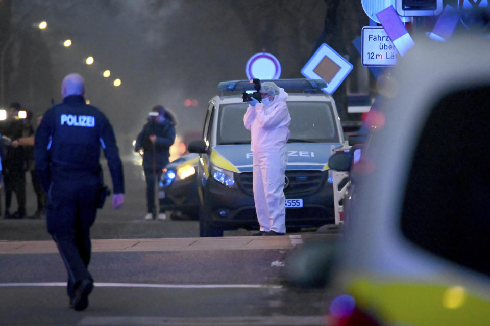 Police and forensic teams work at a level crossing near Brokstedt station in Brockstedt, Germany, Wednesday, Jan. 25, 2023. A man stabbed and wounded several people on a train in northern Germany on Wednesday before police detained him, and two of the victims died, German news agency dpa reported. (Jonas Walzberg/dpa via AP)