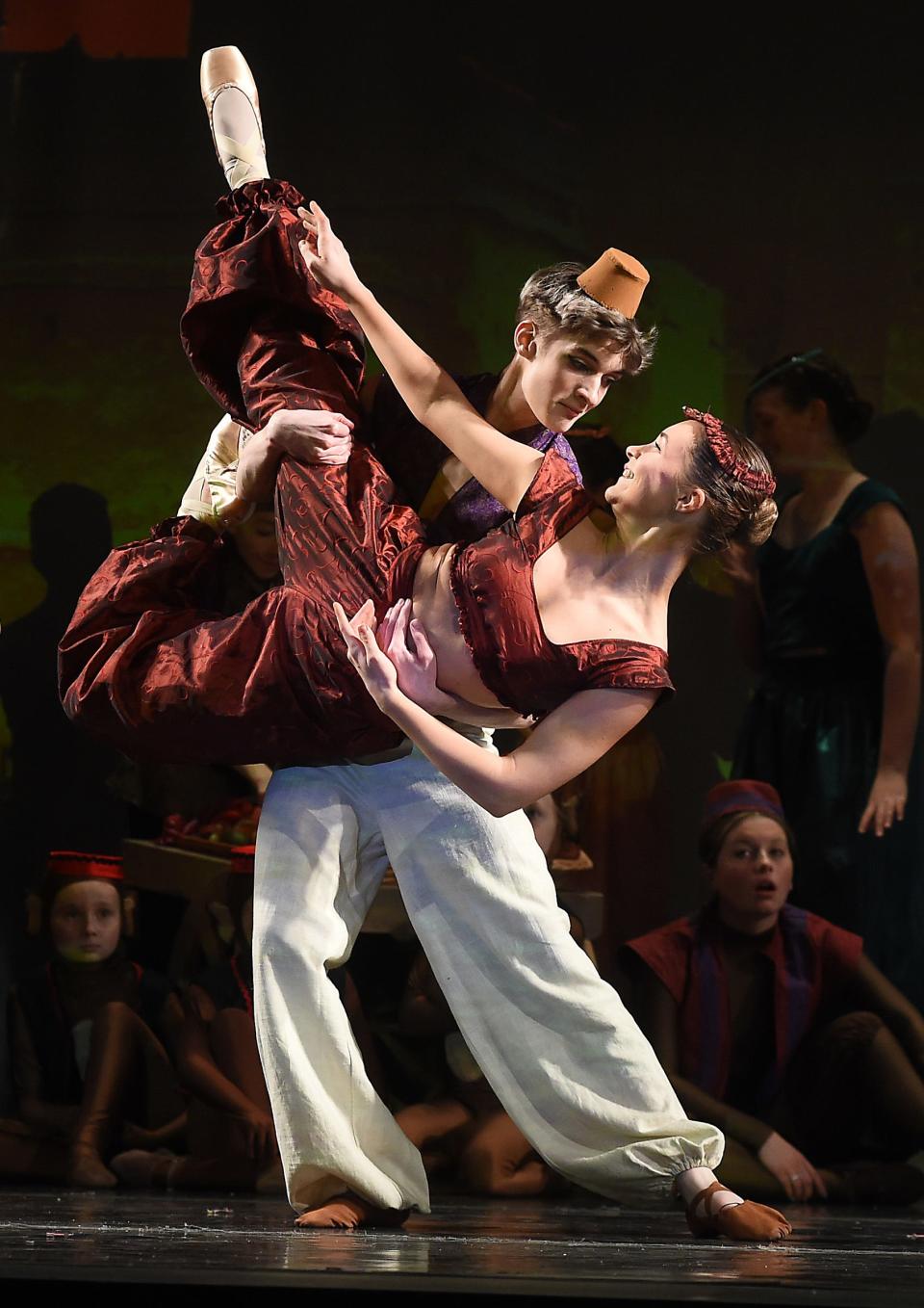 Nathan Glover as Aladdin lifts Emily Bellino as Jasmine in the marketplace scene in the first act of Aladdin.
