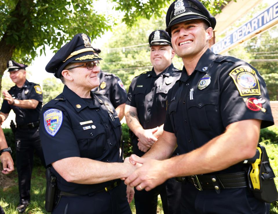 Stoughton Police Chief Donna McNamara congratulates Easton Police Officer Corey McLaughlin at a press conference outside the Easton public safety building on Wednesday, July 5, 2023. McNamara was one of three officers who rescued Emma Tetewsky, 31, of Stoughton, who was stuck in the mud at Borderland State Park for upward of three days.