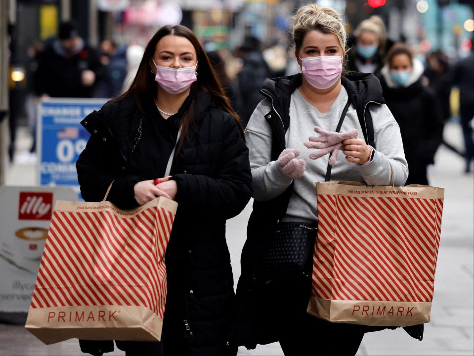 Shoppers carry Primark bags as they walk along Bond Street in London (AFP via Getty Images)