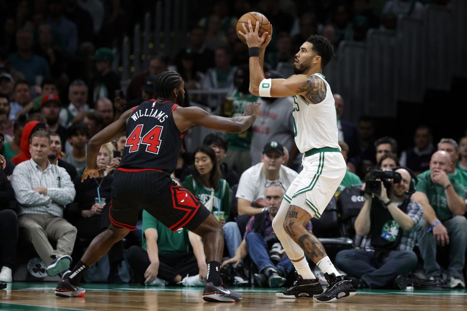 Boston Celtics' Jayson Tatum, right, shoots over Chicago Bulls' Patrick Williams (44) during the first half of an NBA basketball game, Friday, Nov 4, 2022, in Boston. (AP Photo/Michael Dwyer)