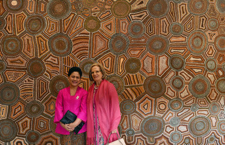 Indonesian's first lady Iriana Widodo (L) and Lucy Turnbull, wife of Australia's Prime Minister Malcolm Turnbull, pose for photos in front of Bark painting by artist Uta Uta Tjangala from the Aboriginal and Torres Strait Islander collection at the Art Gallery of New South Wales in Sydney on February 26, 2017. REUTERS/Saeed Khan/Pool