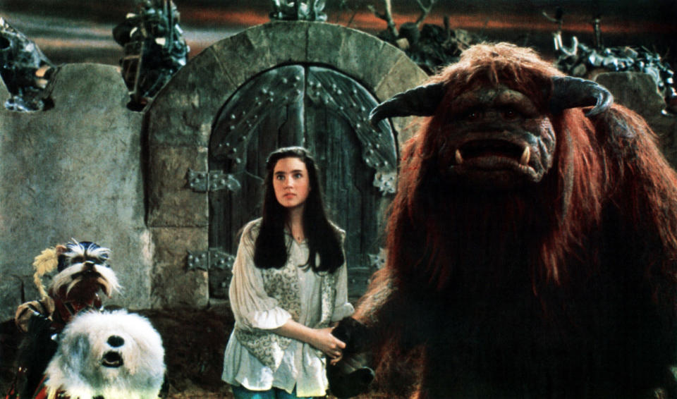 'Labyrinth' star Jennifer Connelly stands between Jim Henson Creature Shop created puppets Sir Didymus (left) and Ludo (right). (Photo: TriStar Pictures/Courtesy Everett Collection)