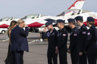 President Donald Trump, accompanied by first lady Melania Trump, greets members of the U.S. Air Force Thunderbirds at Daytona Beach International Airport, Sunday, Feb. 16, 2020, in Daytona Beach, Fla. Trump was at the NASCAR Daytona 500 auto race at Daytona International Speedway. (AP Photo/Alex Brandon)