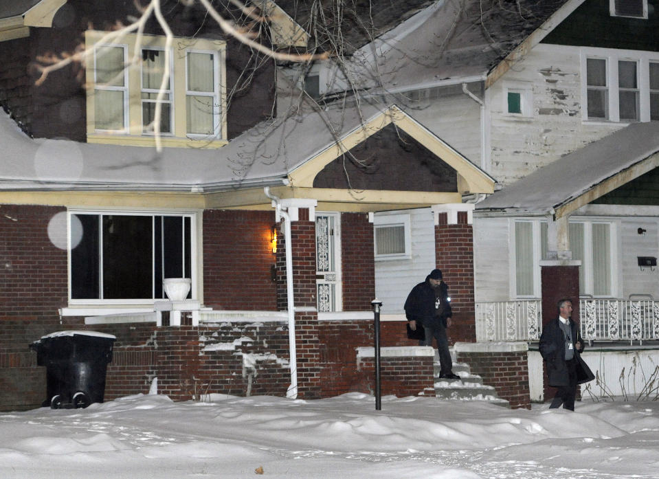 A Detroit Police Officer and an investigator exit a home, just four houses away from where a four year old boy was shot with a rifle on Thursday, Jan. 16, 2014 in Detroit. A 4-year-old girl accidentally shot her 4-year-old cousin to death with a loaded rifle that she found under a bed at their grandfather's Detroit home, police said Friday. The girl was playing and watching TV on Thursday afternoon with the 4-year-old boy and his 5-year-old sister when she found the gun, police Sgt. Michael Woody said. He said she picked up the weapon, pointed it at the boy and shot him once in the chest. (AP Photo/Detroit News, Jose Juarez) DETROIT FREE PRESS OUT; HUFFINGTON POST OUT