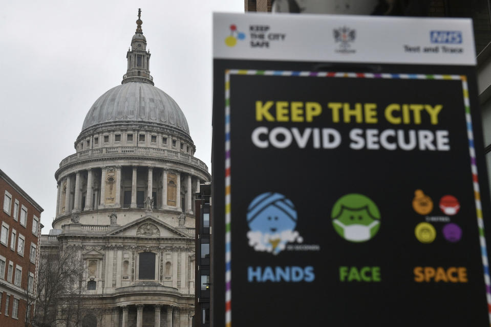Covid-19 signage in front of St Paul's Cathedral, after Mayor of London Sadiq Khan declared a "major incident" as the spread of coronavirus threatens to "overwhelm" the capital's hospitals during England's third national lockdown to curb the spread of coronavirus, in London, Friday, Jan. 8, 2021. (Dominic Lipinski/PA via AP)