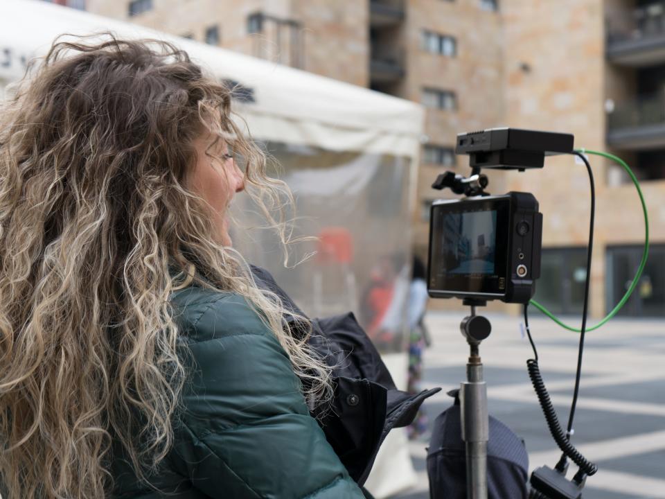 Federica Busani holds a film camera in a city