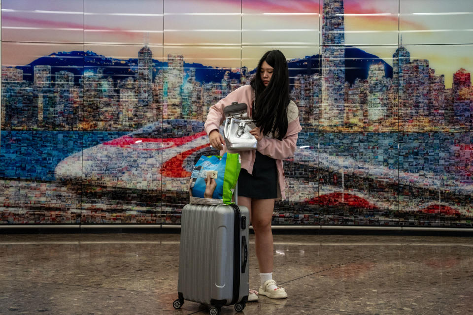 A woman is standing with her luggage in the arrival hall inside the West Kowloon High Speed Railway Station in Hong Kong, on May 1, 2024. (Photo by Vernon Yuen/NurPhoto via Getty Images)