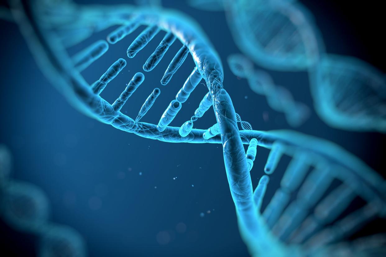 Focus on one DNA molecule in shades of blue on a darker blue background, surrounded by more blurred DNA molecules