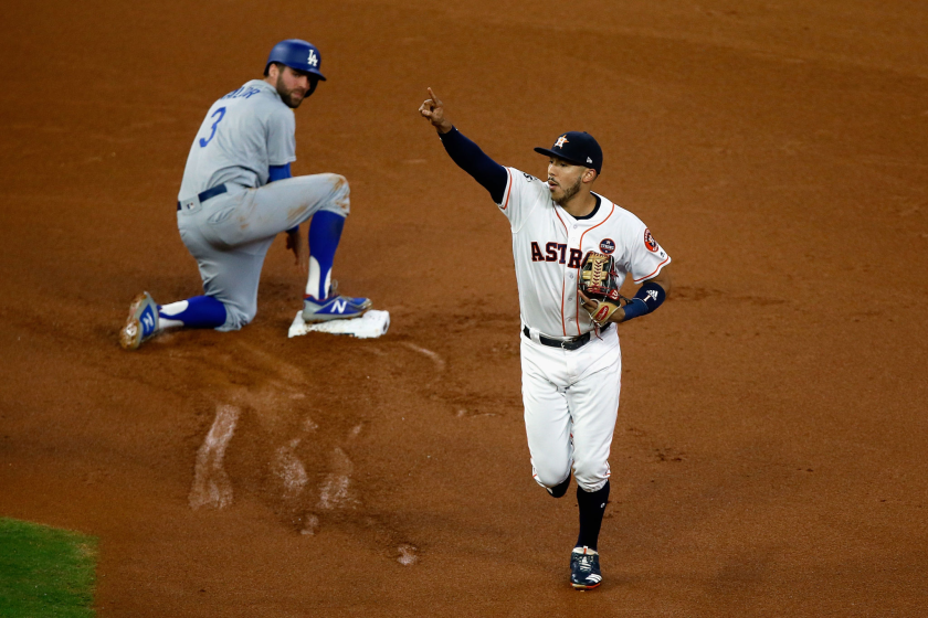 Astros shortstop Carlos Correa celebrates after after tagging out Dodger Chris Taylor