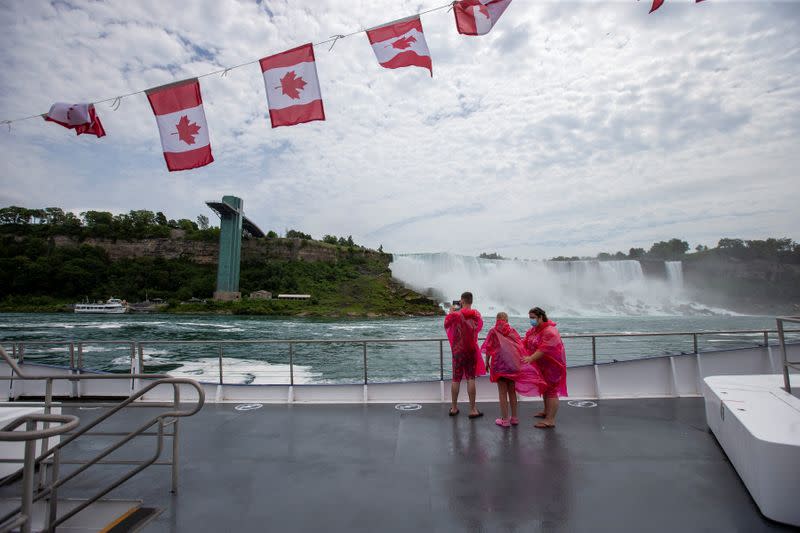 Jose Mannucci, Mariah Wilson and Jasmine Demers ride the Canadian tourist boat Hornblower, limited under Ontario's rules to just six passengers amid the spread of the coronavirus disease (COVID-19), in Niagara Falls