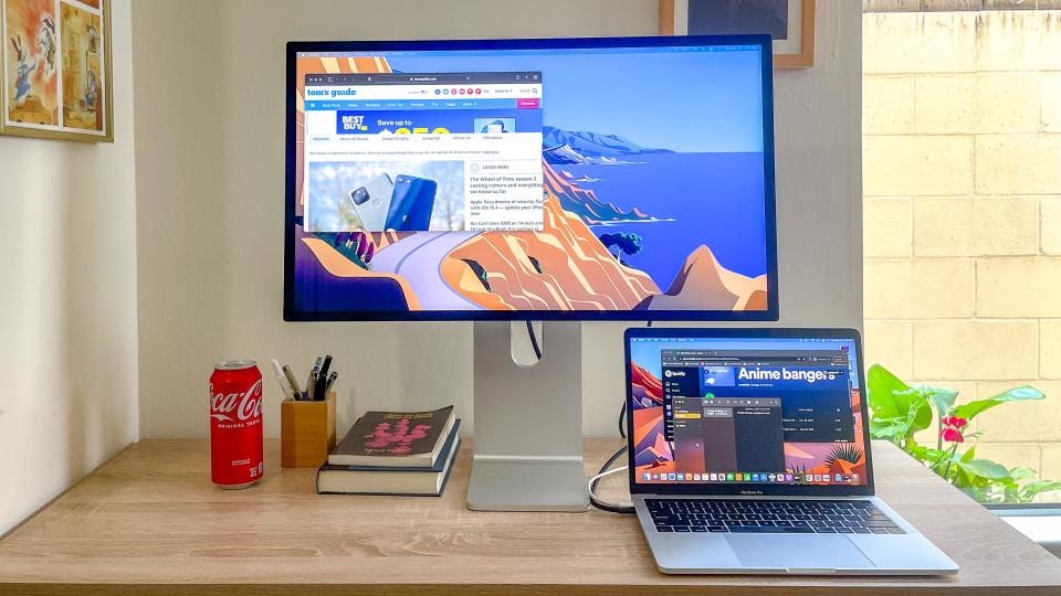 Apple Studio Display with MacBook Pro (2019) connected and playing music via Spotify