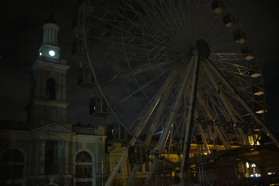 City lighting turned off at twilight in Kyiv downtown, Ukraine, Monday, Oct. 31, 2022. Rolling blackouts are increasing across Ukraine as the government rushes to stabilise the energy grid and repair the system ahead of winter. (AP Photo/Andrew Kravchenko)