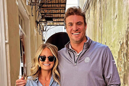 Shep Rose and Cameran Eubanks posing together in casual outfits in an alleyway.