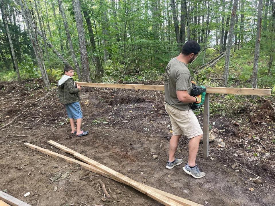 Jacob Hartford and his dad, Timothy, working in the woods to make his Halloween vision a reality.
