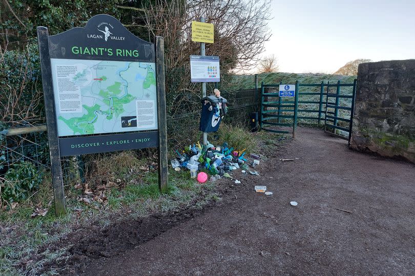 General mess at the Giant's Ring on the outskirts of Belfast with overflowing bin seen here next to gate and information sign about area