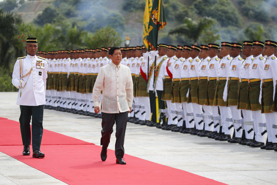 Philippine President Ferdinand Marcos Jr., right, inspects the Royal Malay Regiment guard of honor during the state welcome ceremony at National Palace in Kuala Lumpur, Malaysia Wednesday, July 26, 2023. (Fazry Ismail/Pool Photo via AP)