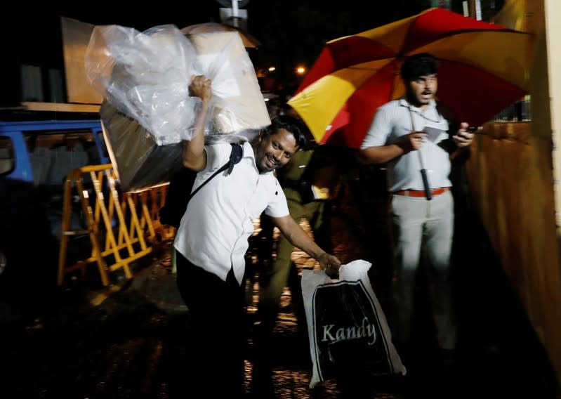 A Sri Lankan election official arrives with a ballot box to a counting center after the voting ended during the presidential election day in Colombo