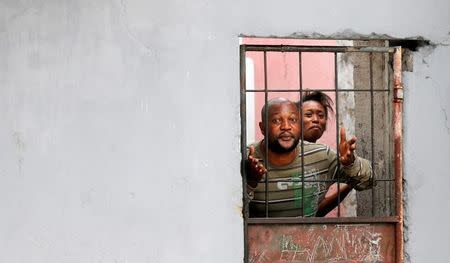 Residents chant slogans against Congolese President Joseph Kabila behind their closed door during demonstrations in the streets of the Democratic Republic of Congo's capital Kinshasa, December 20, 2016. REUTERS/Thomas Mukoya