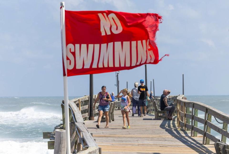 No Swimming flags flap in the wind on Avon Pier Thursday Sept, 15, 2023 as Hurricane Lee churns in the Atlantic hundreds of miles offshore.