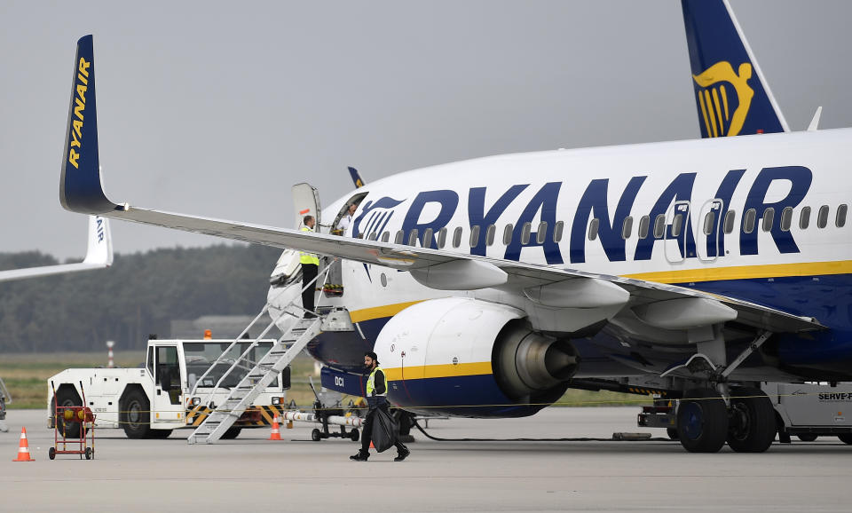 FILE - In this Sept. 12, 2018 file photo, a Ryanair plane parks at the airport in Weeze, Germany. Europe's busiest airline, Ryanair, said Monday Feb. 3, 2020, that the grounding of the new Boeing Max jets will delay its growth targets. The budget carrier, which is based in Ireland and carries more passengers than any other airline in Europe, plans to extend by a year or two its target of flying 200 million people per year. (AP Photo/Martin Meissner, File)